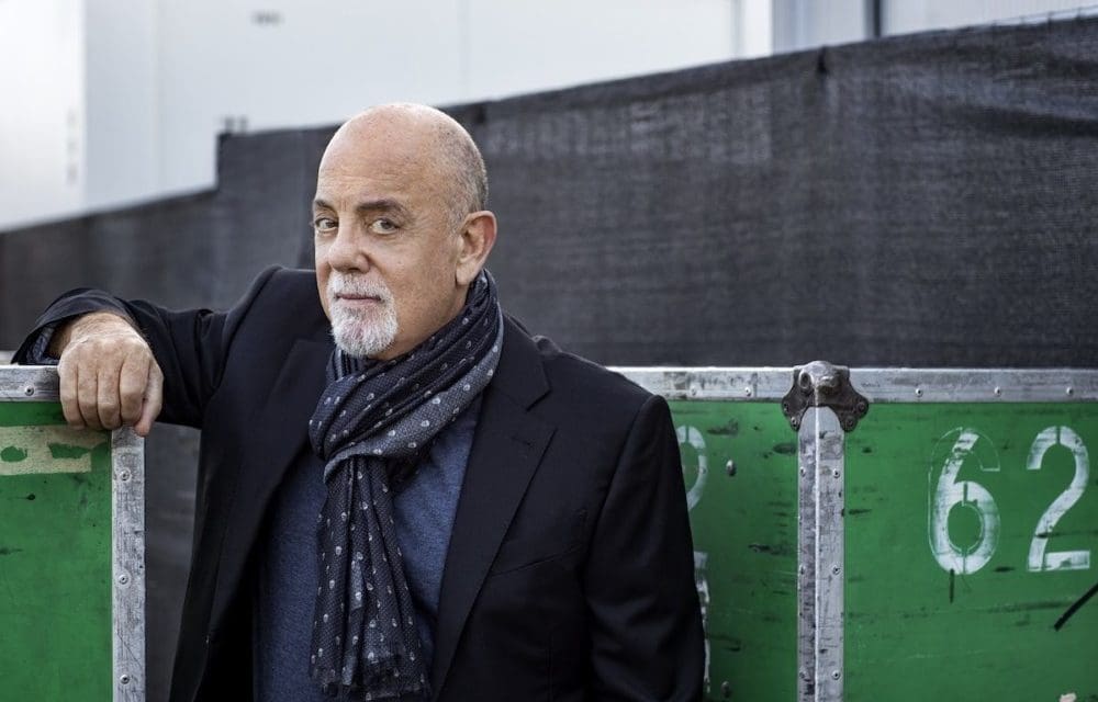 Billy Joel smiles at the camera