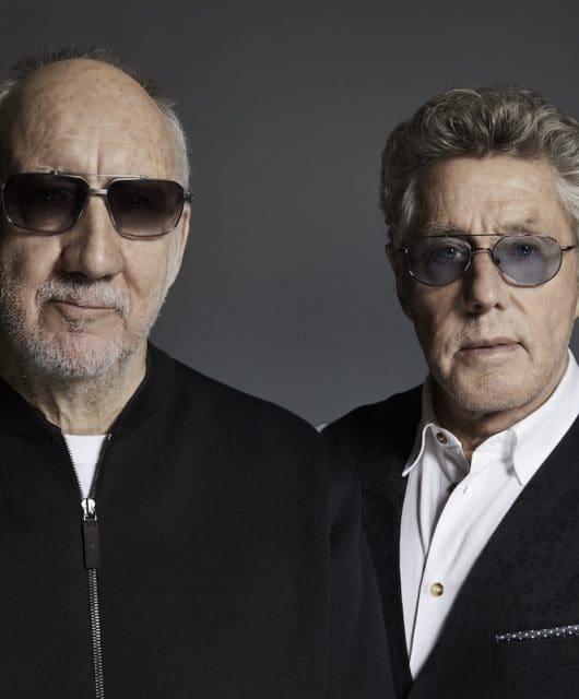 Pete Townshend and Roger Daltrey of The Who stand side by side facing forward