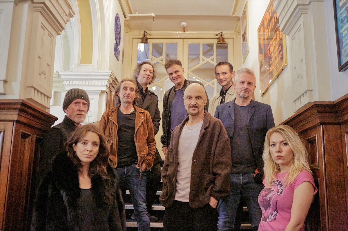 The Band James Pictured On Stairs Facing The Camera